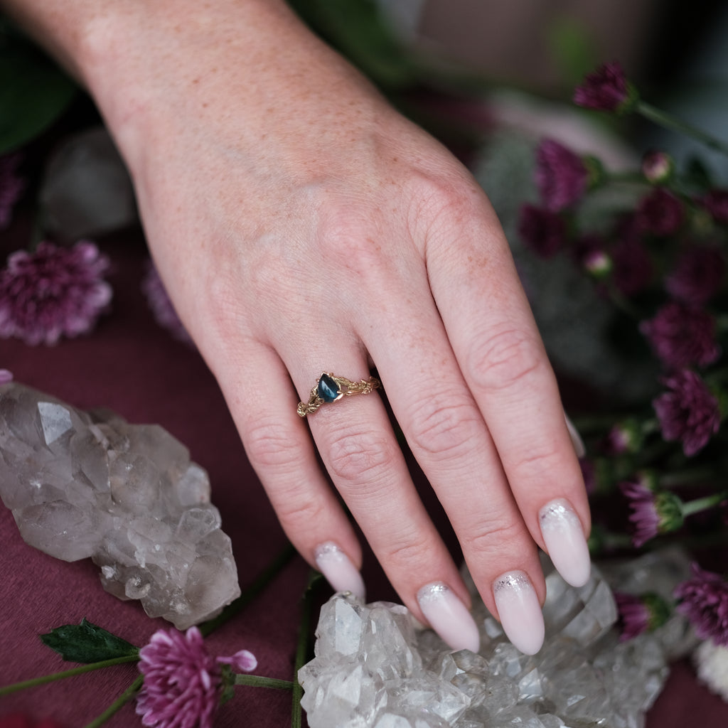 14K Yellow Gold Ring “Bloom” with Blue Tourmaline in hand