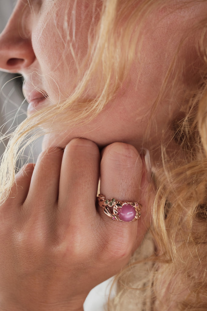Organic botanical gold ring with sculpted lunar hares and luminous star ruby