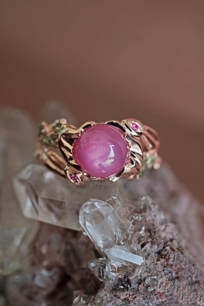 Women's fine 14K gold ring featuring a luminous pink star ruby.