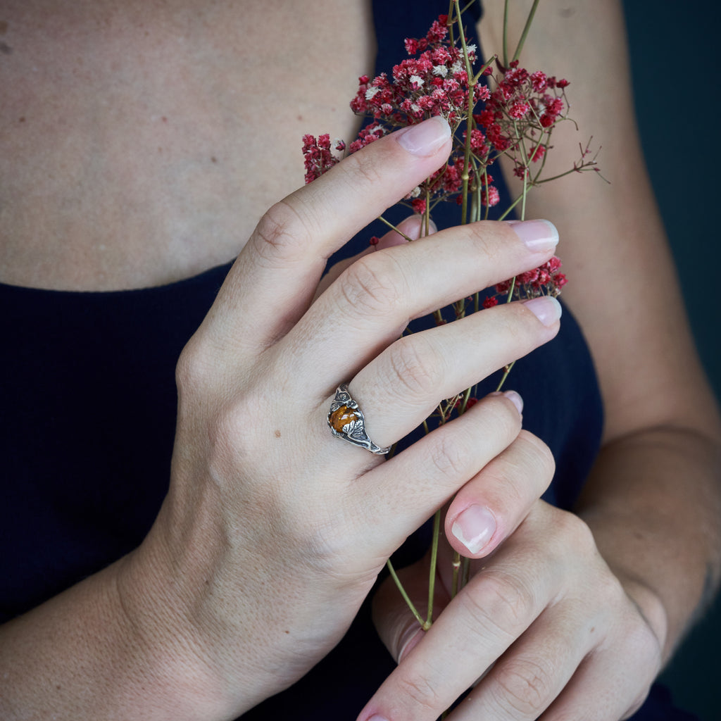 Amber ring "Daisy" on hand
