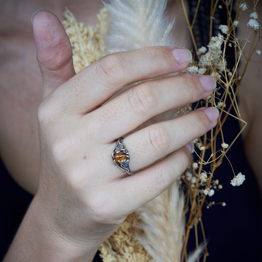 Amber ring "Daisy" on hand